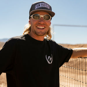 Front view of a rider wearing the Black Fun-Haver® Shield Logo T-Shirt at the track