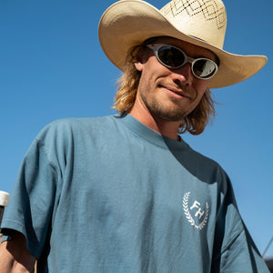 Front view of a rider wearing the Sea Blue Fun-Haver® Shield Logo T-Shirt at the track