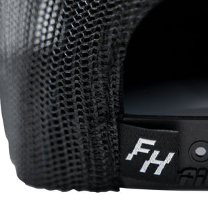 Detail view of the FH logo on the back of the Fun-Haver® Shield 6 Panel Trucker Hat