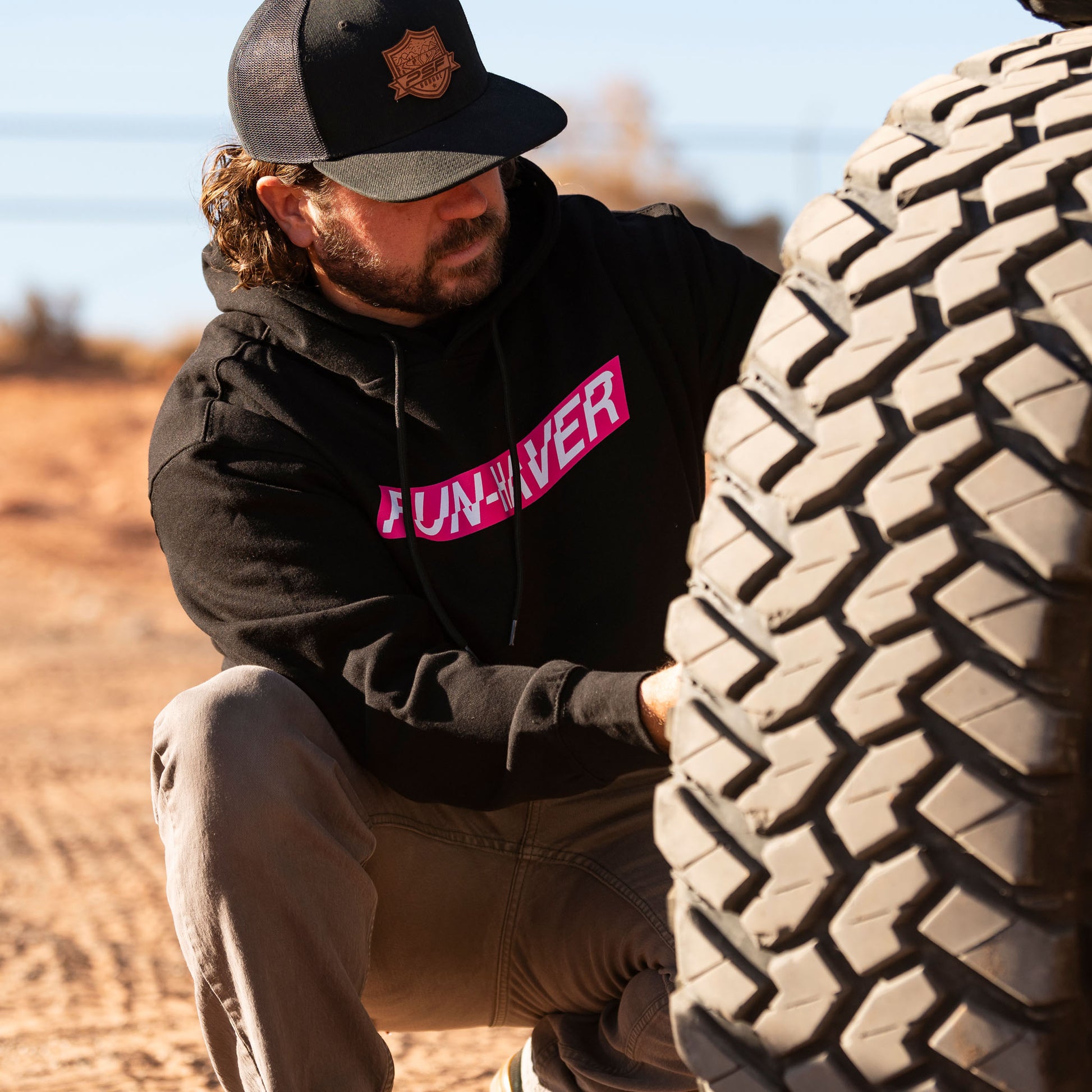 Fun-Haver wearing the Black Fun-Haver Energy Pullover Hoodie getting the off-road rig ready for some four wheel adventures