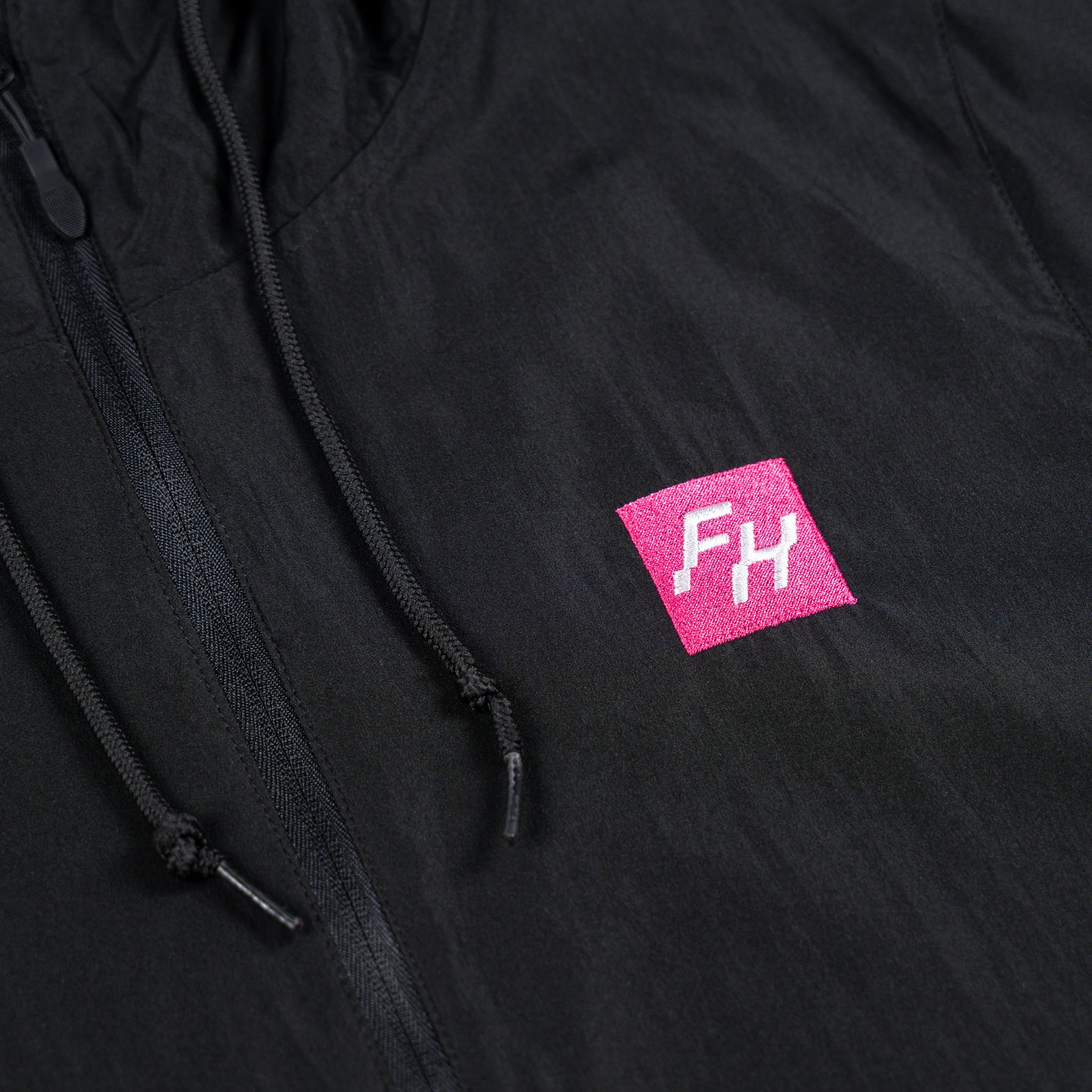 Chest detail view of the Black Fun-Haver Energy Windbreaker Anorak Jacket 