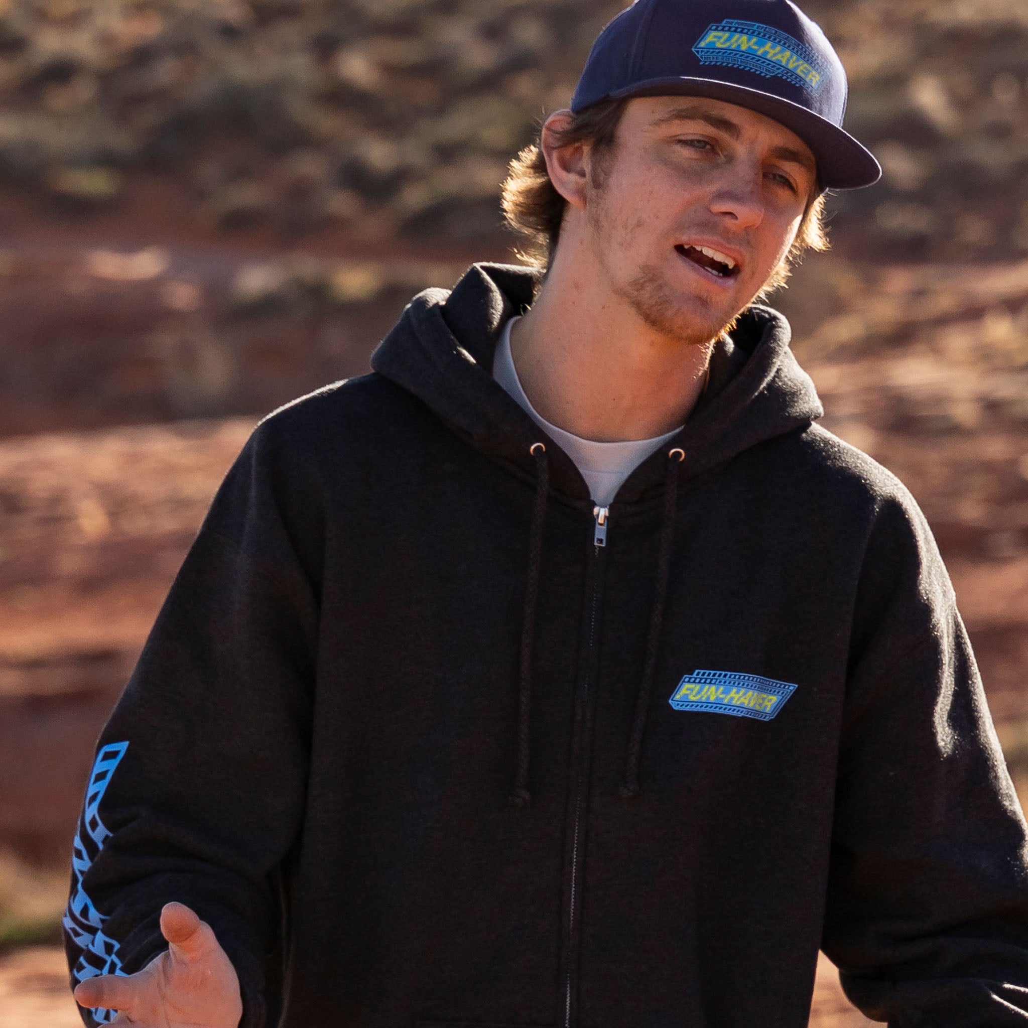 The Fun-Haver Pursuit Zip Hoodie in Charcoal Heather out in its element in the desert