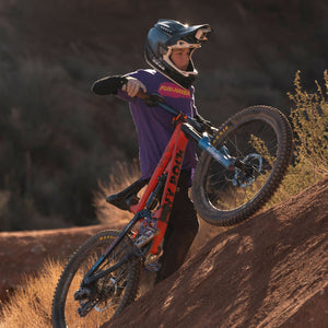 Future lifelong Fun-Haver wearing the Fun-Haver Purple Rush Pursuit Youth T-Shirt with Magenta and Yellow Fun-Haver logo graphics out in the desert in pursuit of fun