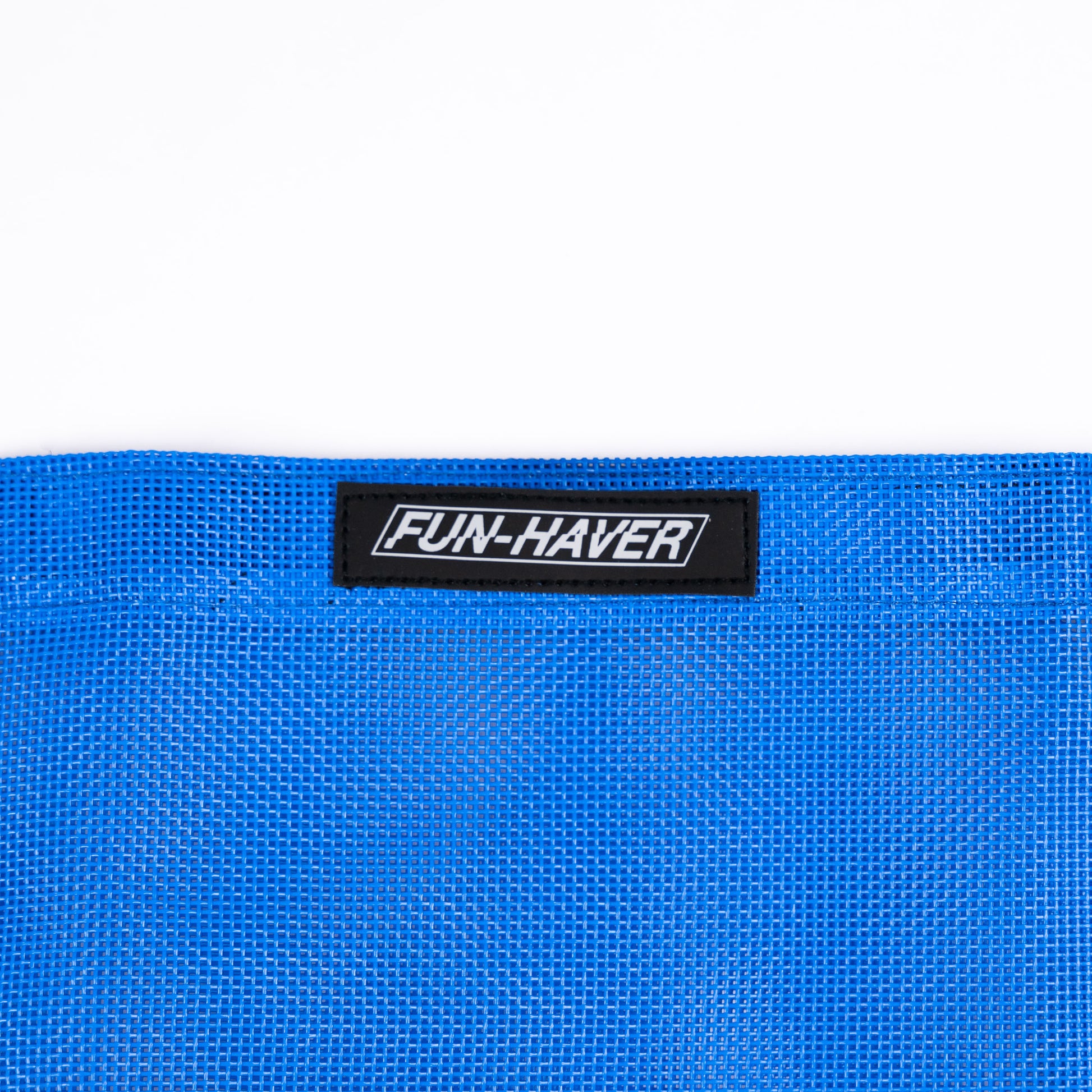 Detail view of the Blue Fun-Haver Trail Bag stitched on Fun-Haver logo tag.