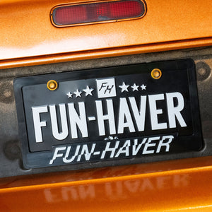 Fun-Haver logo license plate frame and Full Time metal license plate on Orange Mazda RX-7 FC.