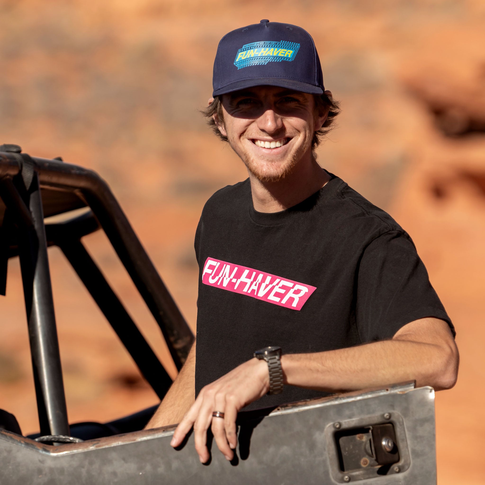 Jake wearing the Black Fun-Haver Energy T-Shirt and Pursuit Snapback Hat out on the trail.