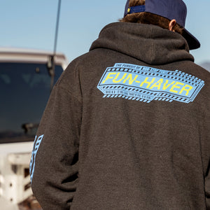 Back view of Jake wearing the Pursuit Zip Hoodie in Charcoal Heather out in its element in the desert.