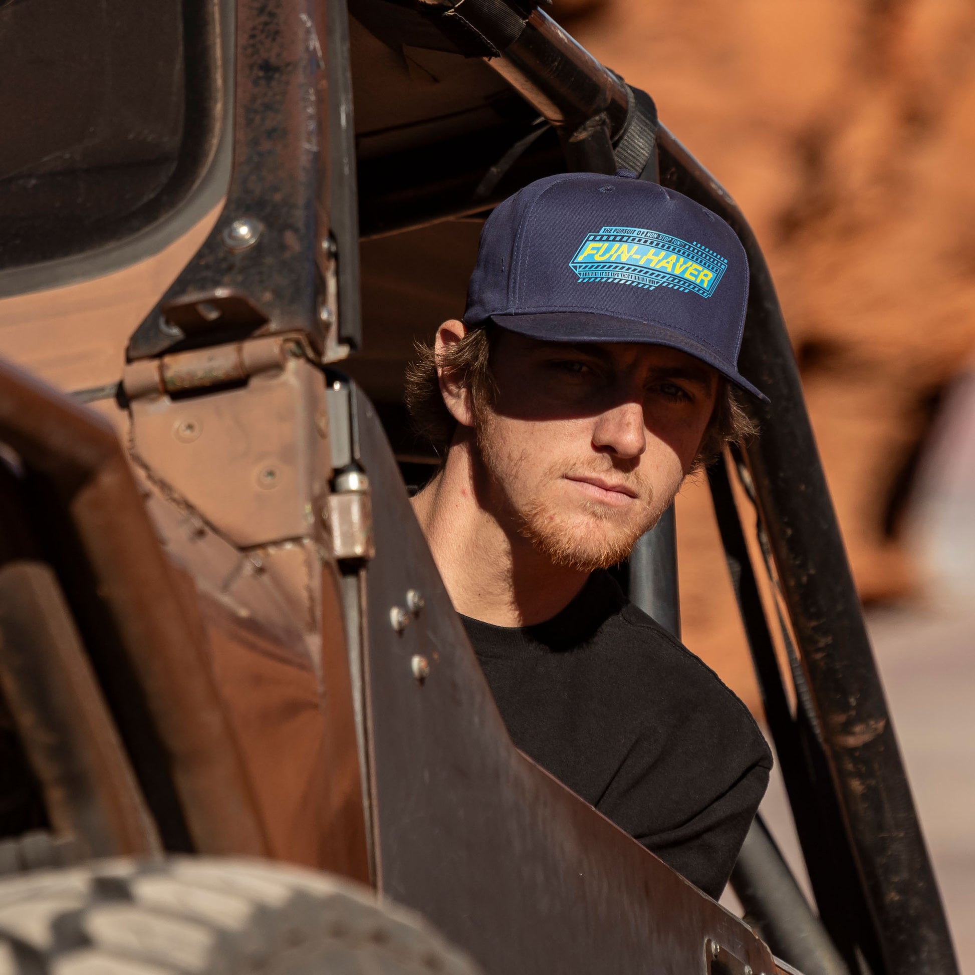 Jake, out on the trail driving his Jeep wearing the Navy Fun-Haver Pursuit Snapback Hat.