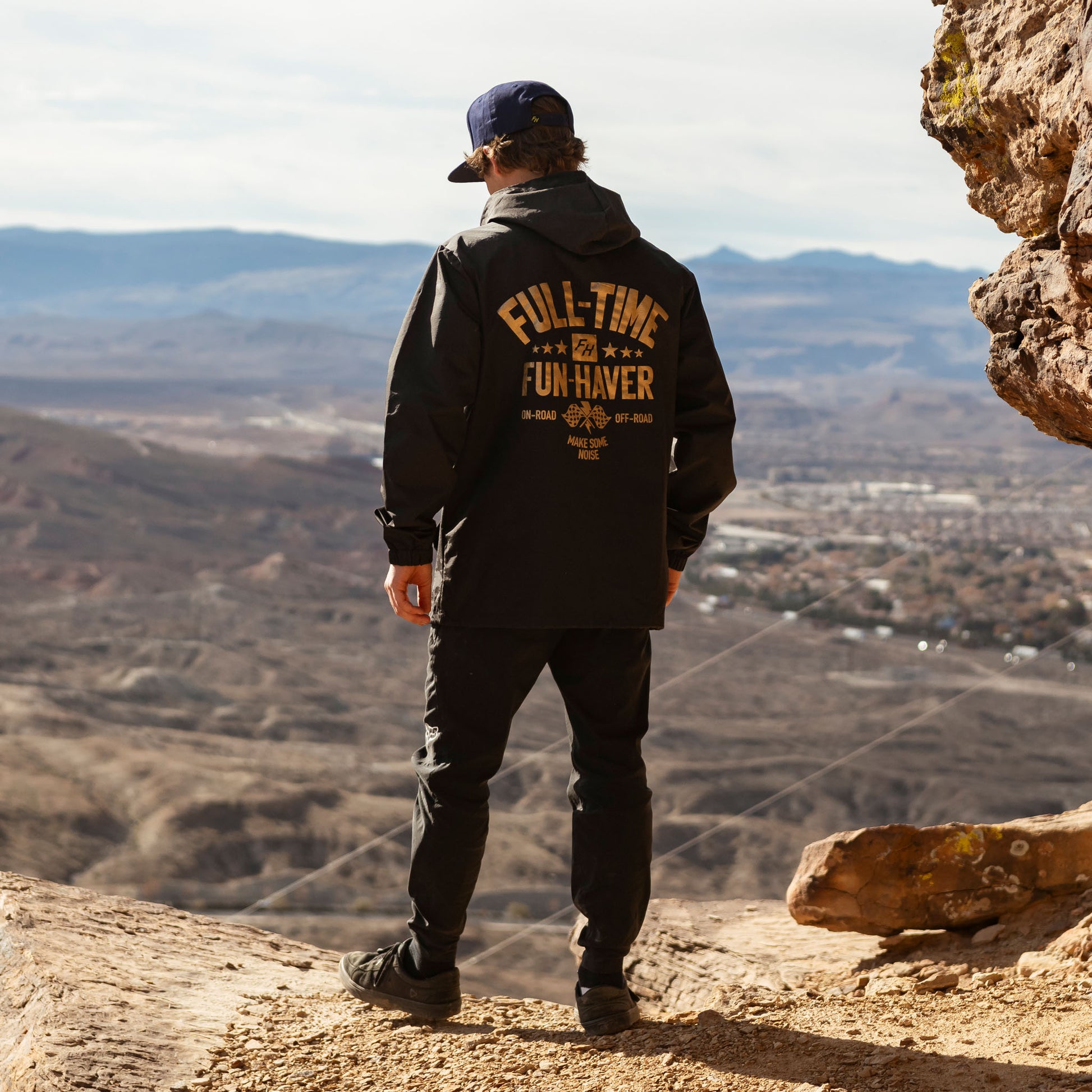 Back view of Joel wearing the Black Full Time Fun-Haver® Winbreaker Coaches Jacket.