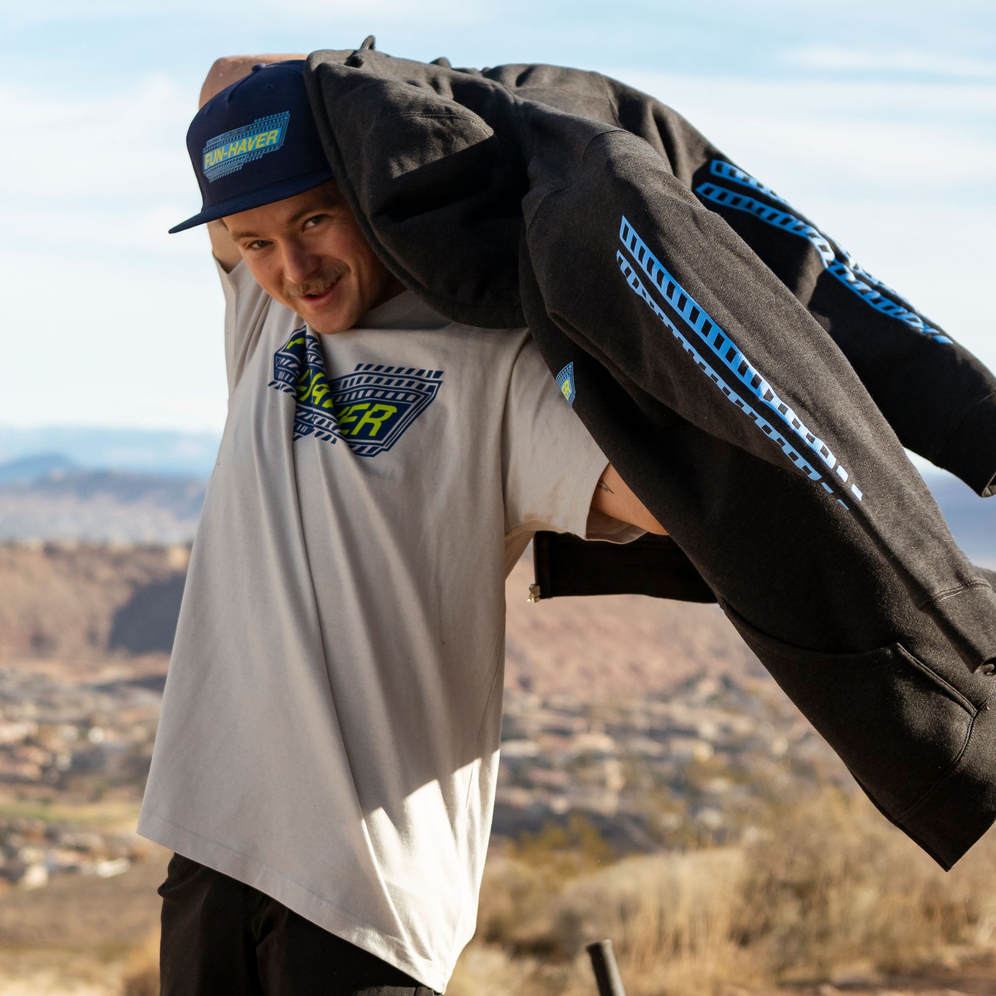 Joel about to put on the Fun-Haver Pursuit Zip Hoodie in Charcoal Heather.