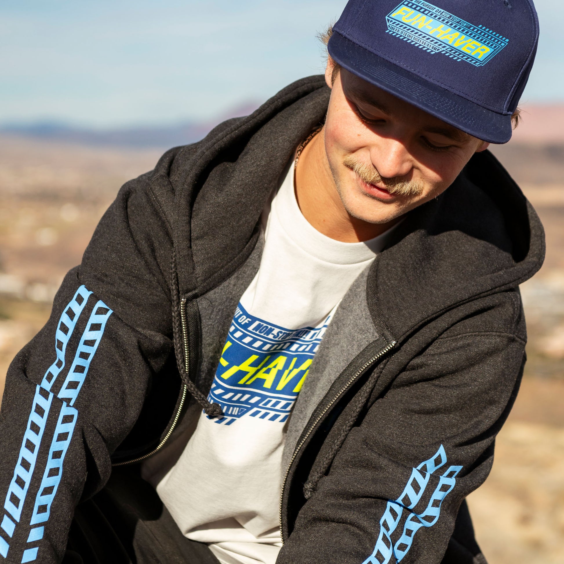 Joel wearing the Fun-Haver Pursuit Zip Hoodie in Charcoal Heather.