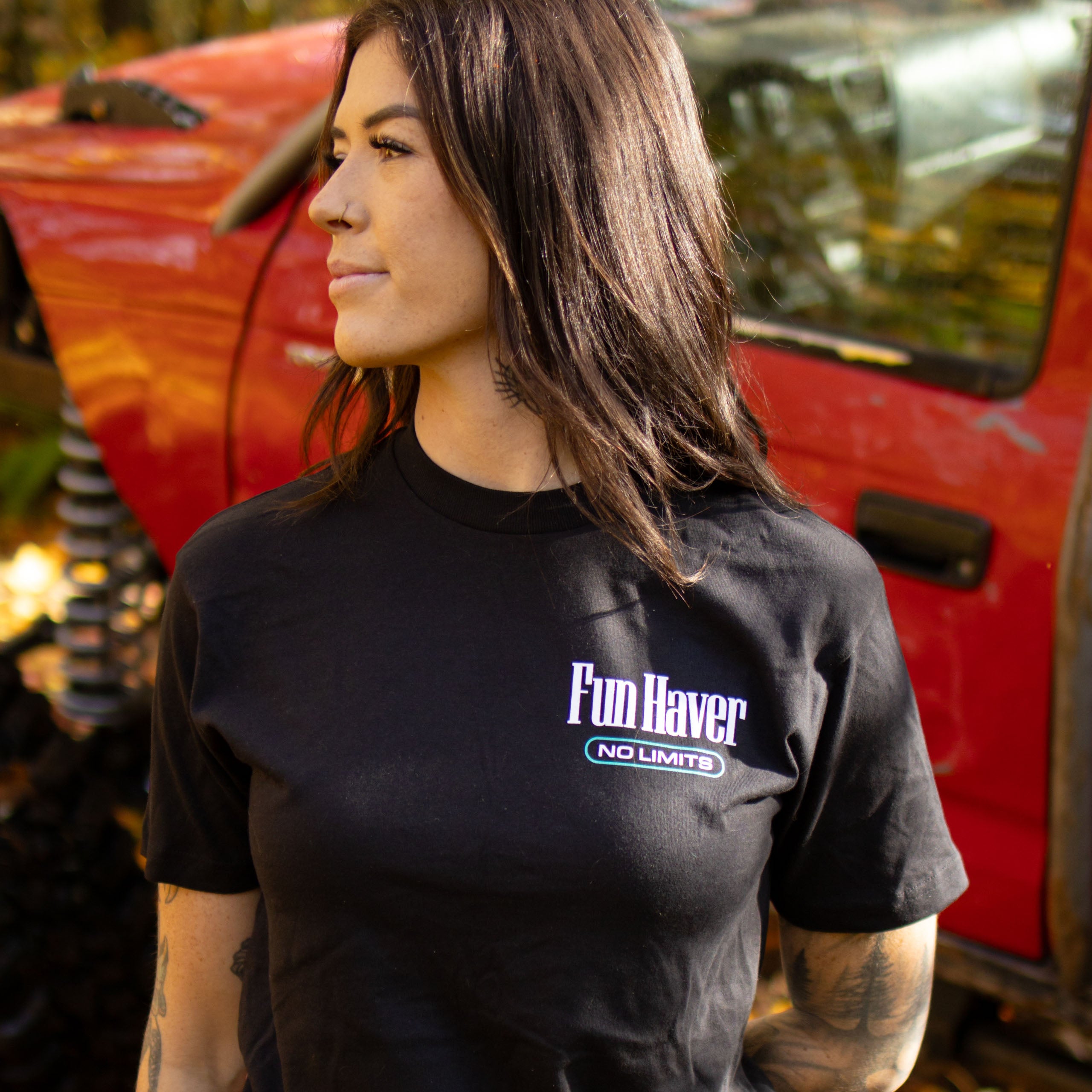 Front view of Kelsie Heck wearing the Fun-Haver No Limits Black T-Shirt in front of her Toyota Tacoma truck.