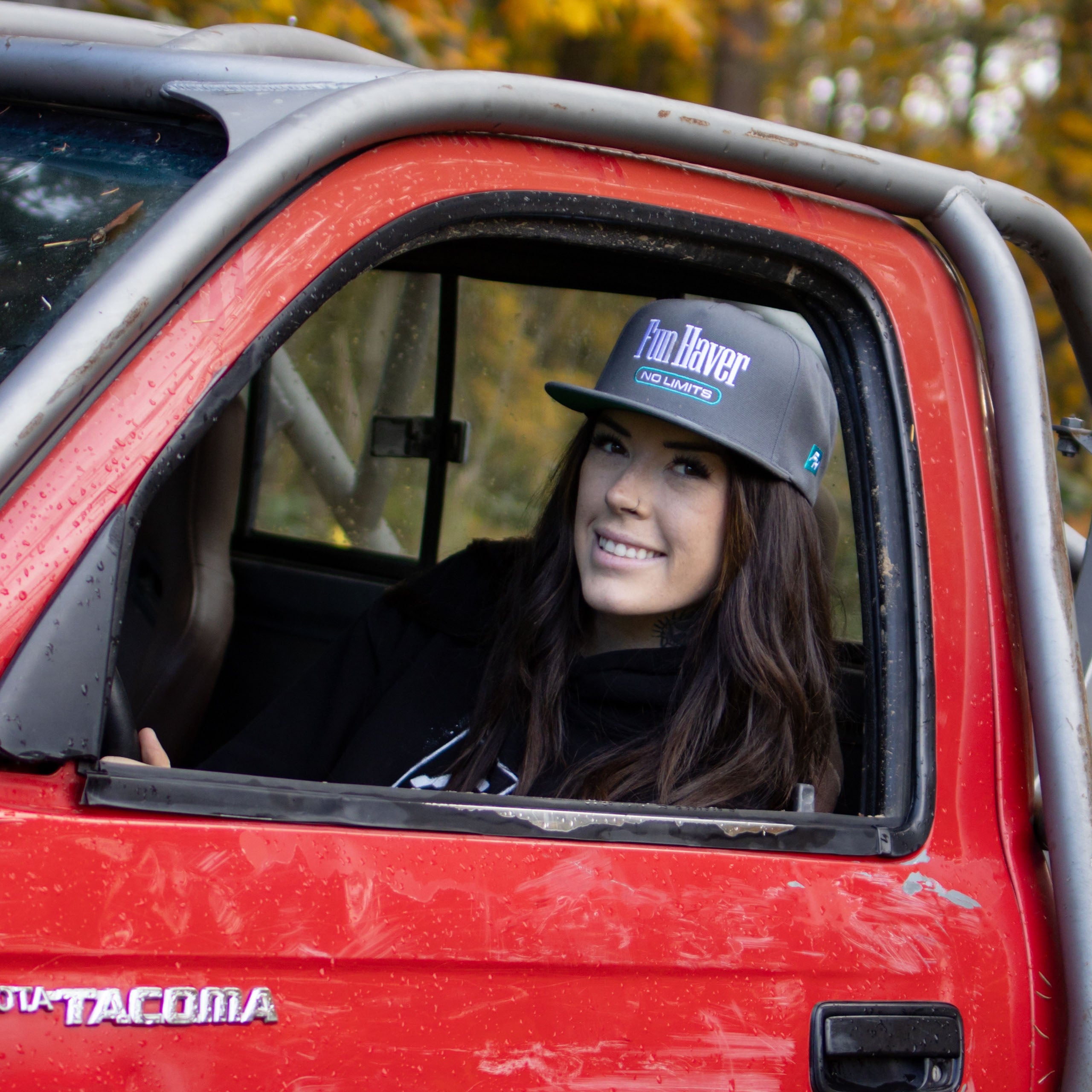 Kelsie Heck wearing the Fun-Haver Grey No Limits Snapback Hat in her Toyota Tacoma