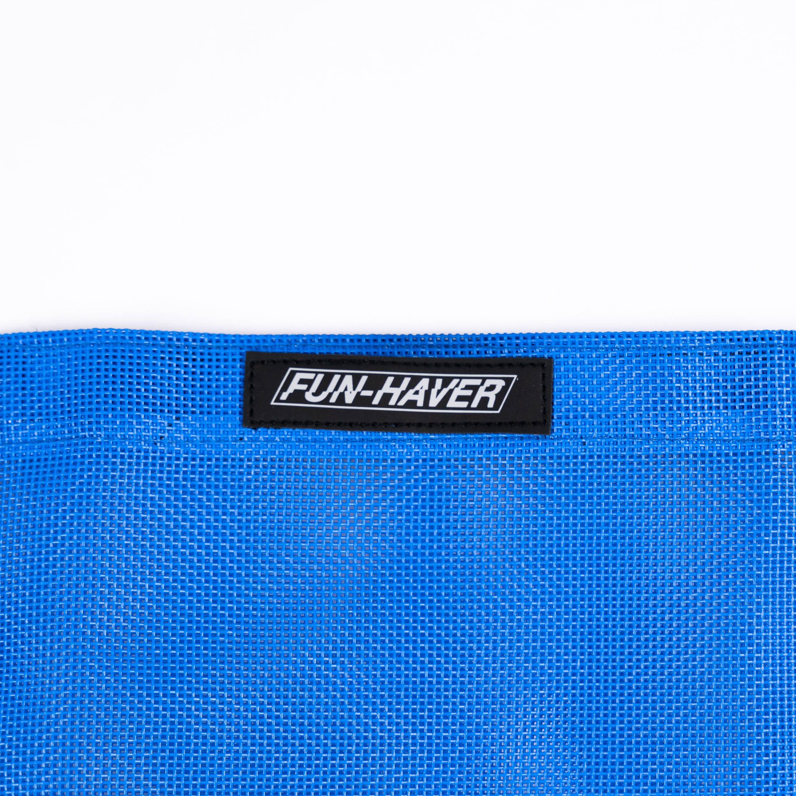 Detail view of the Blue Fun-Haver Trail Bag stitched on Fun-Haver logo tag.
