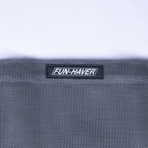 Detail view of the Grey Fun-Haver Trail Bag stitched on Fun-Haver logo tag.