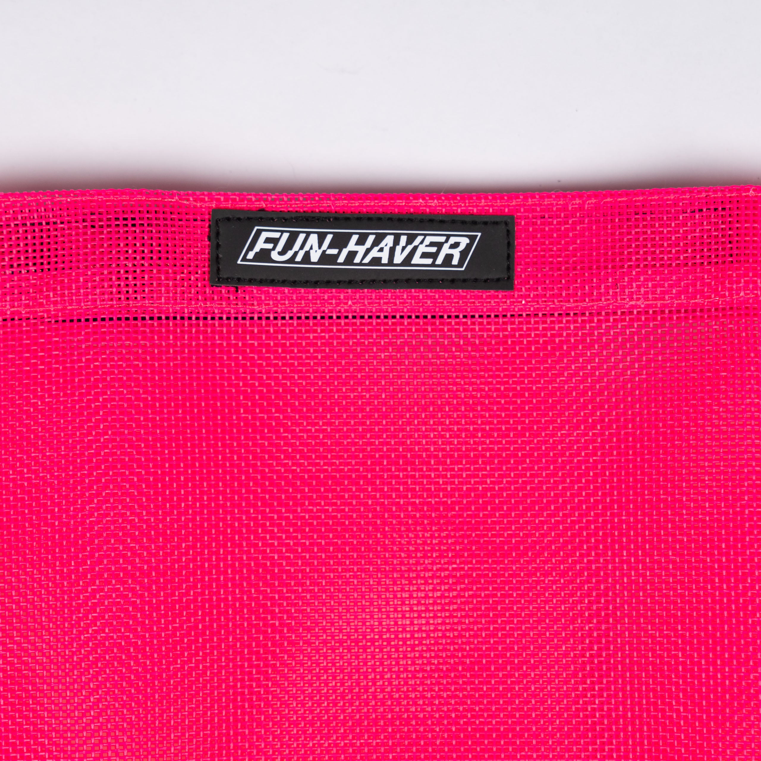 Detail view of the Pink Fun-Haver Trail Bag stitched on Fun-Haver logo tag.