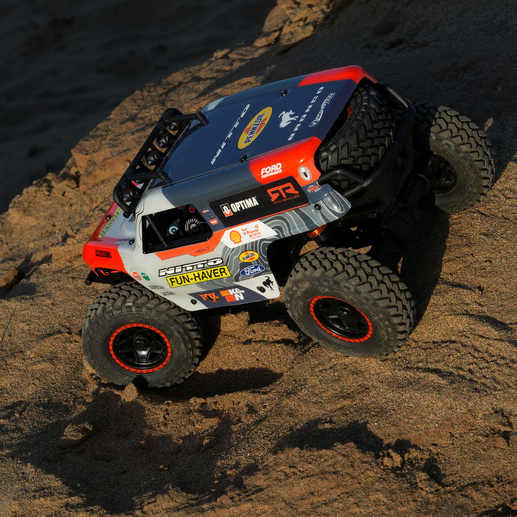 Peeking into the cockpit of the Fun-Haver Loren Healy Hpi Venture 18 1/10th RC Ultra4 Bronco in action in the early evening sun.