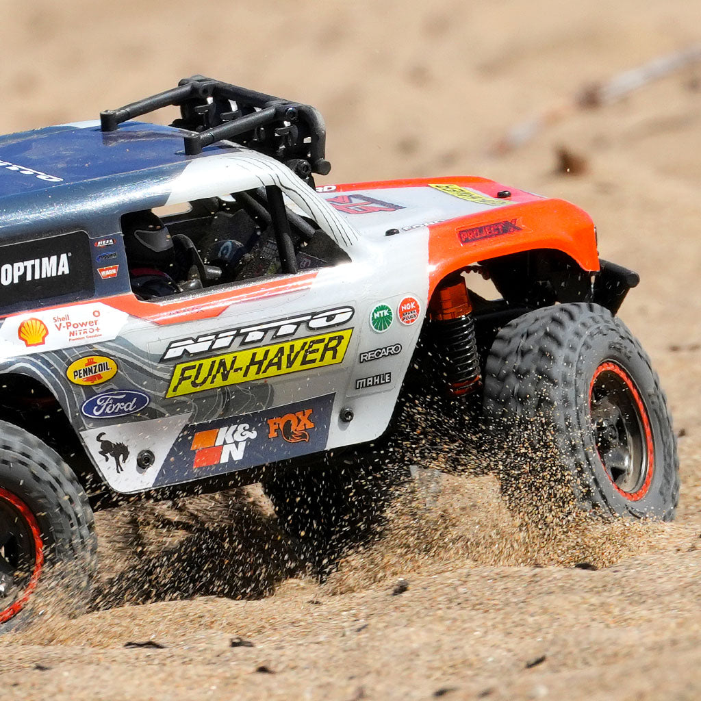 Close up of the Fun-Haver Loren Healy Hpi Venture 18 1/10th RC Ultra4 Bronco in action shredding in the sand.