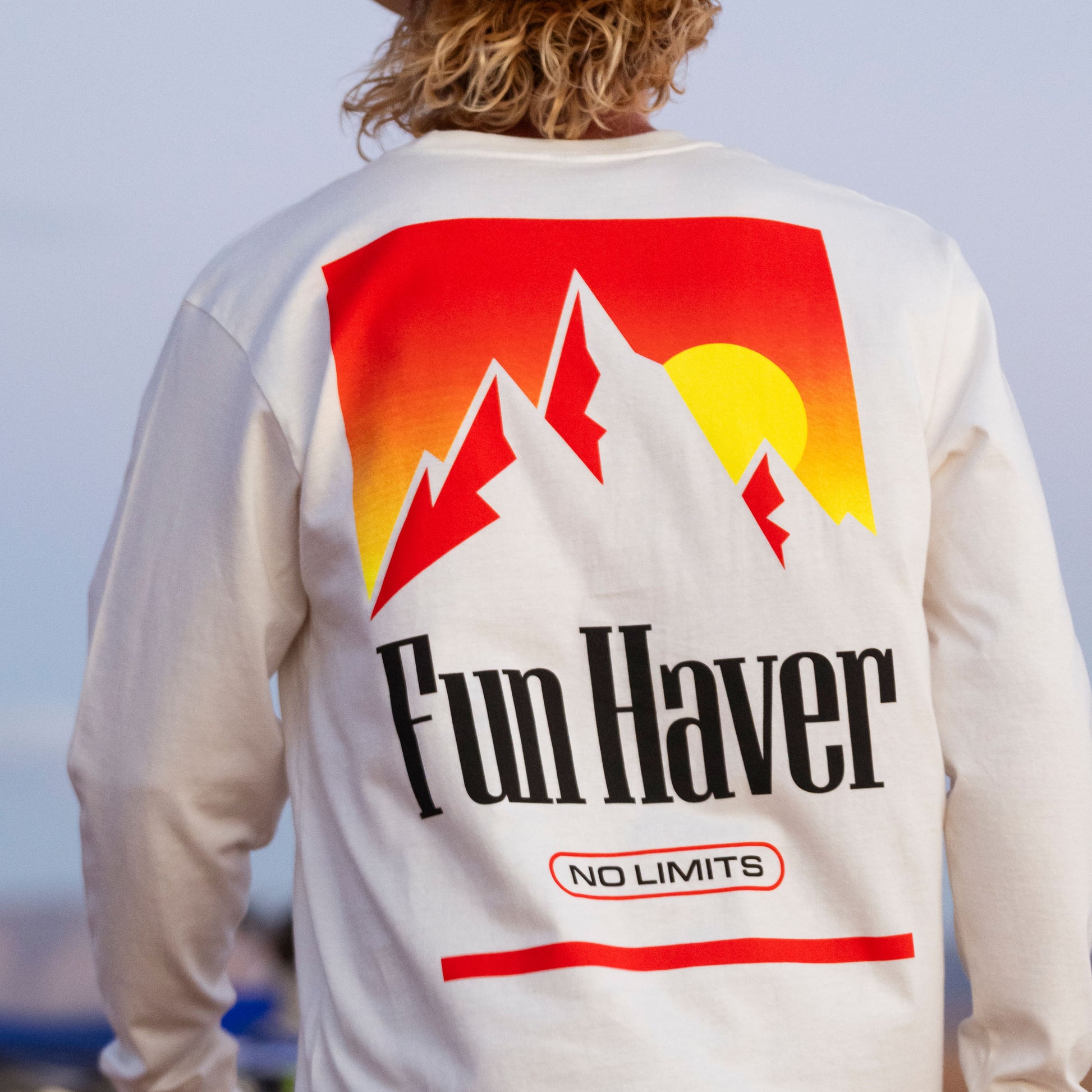 Back view of a motocross rider wearing the Fun-Haver No Limits White Long Sleeve T-Shirt.