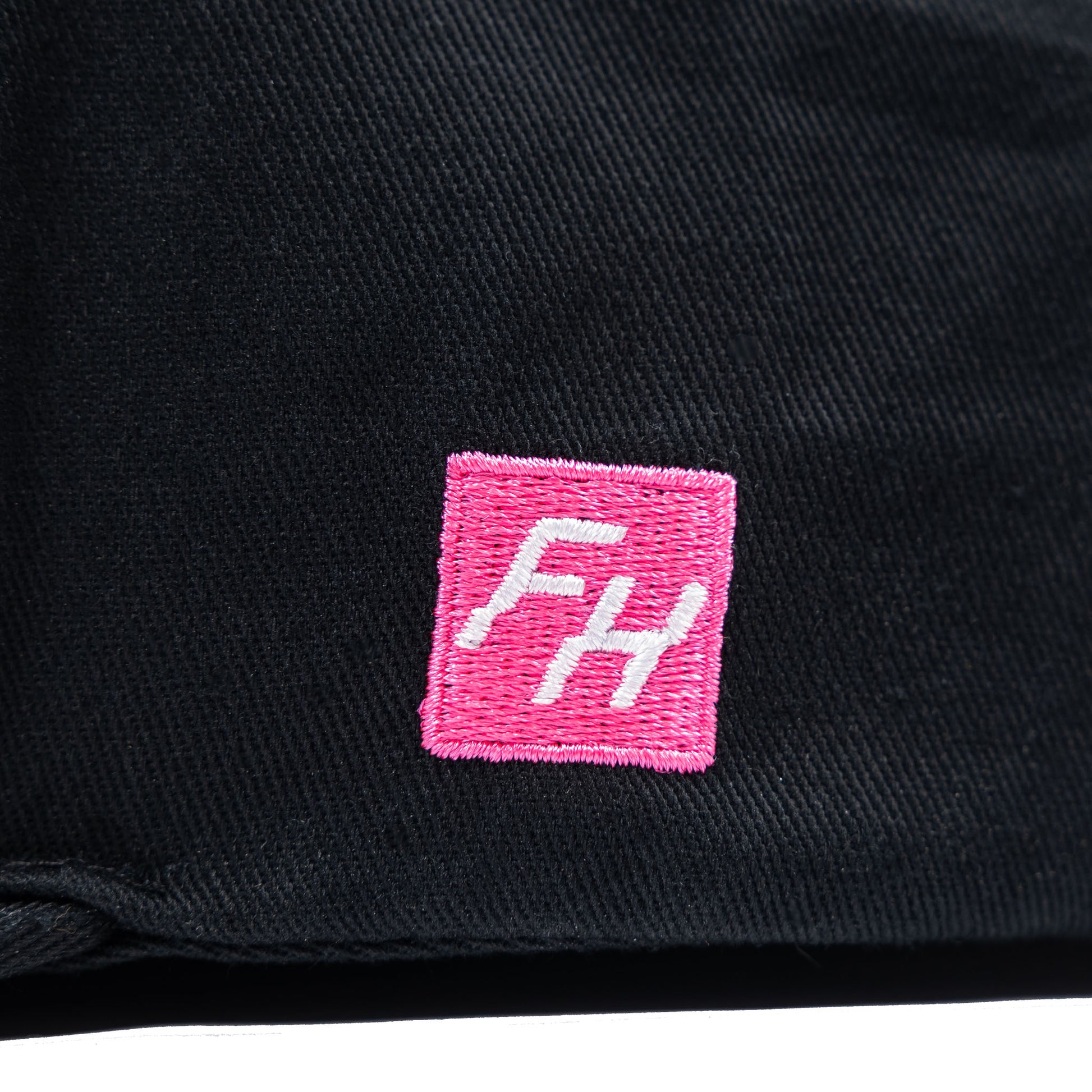 Detail view of the embroidered FH logo on the Fun-Haver Energy Snapback Hat.