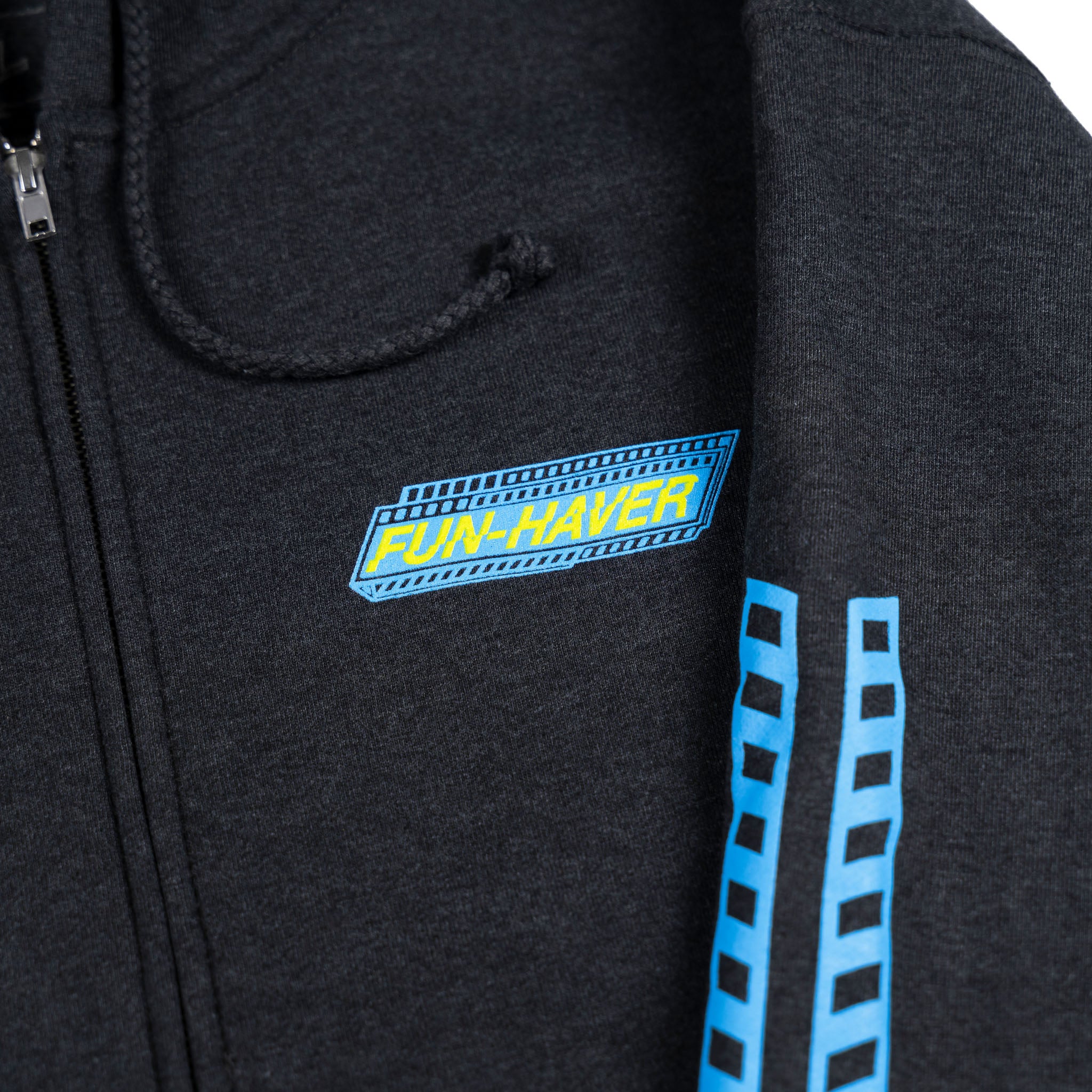 Left chest detail view of the Fun-Haver Pursuit Zip Hoodie in Charcoal Heather.