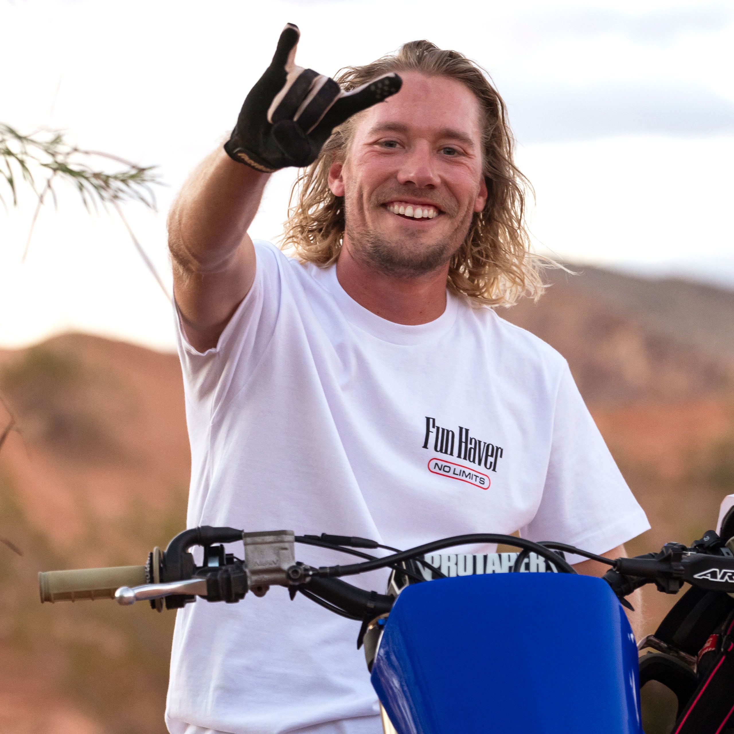 Front view of motocross rider wearing the Fun-Haver No Limits white T-Shirt while sitting on his bike.