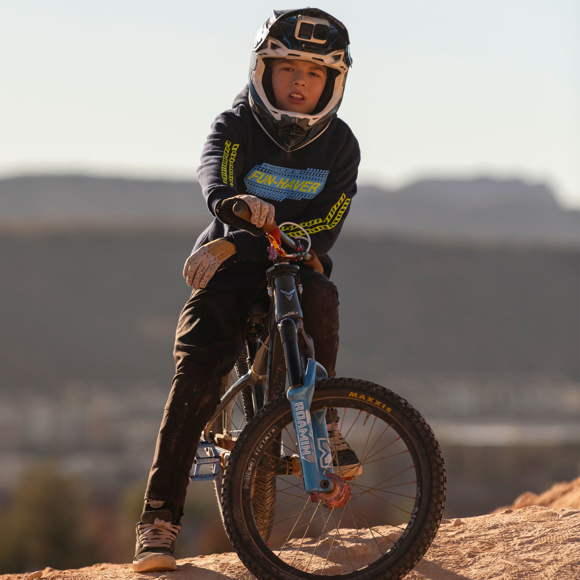 Wes wearing the Fun-Haver Midnight Navy Pursuit Youth Pullover Hoodie sitting on his bike.