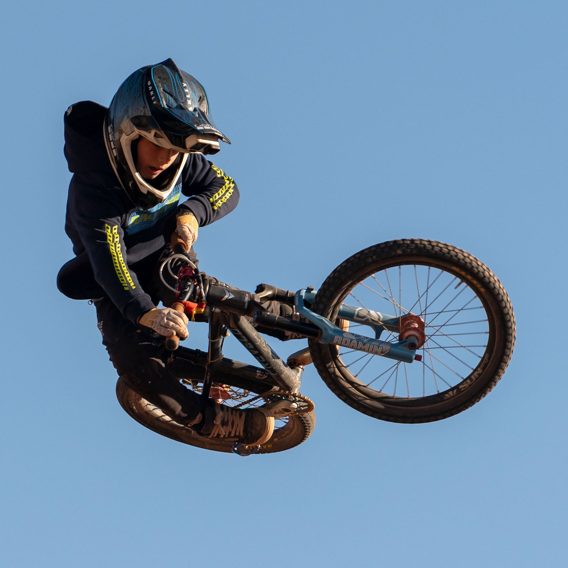Wes catching air on his bike in the Fun-Haver Midnight Navy Pursuit Youth Pullover Hoodie.