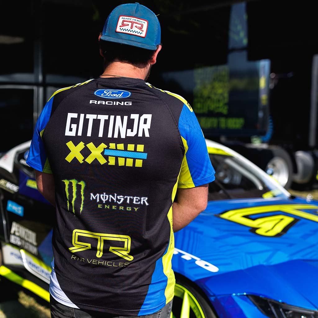 Back view of an RTR Vehicles team member in the 2026 Vaughn Gittin Jr. Drift Team Sublimated shirt at a Formula Drift event.